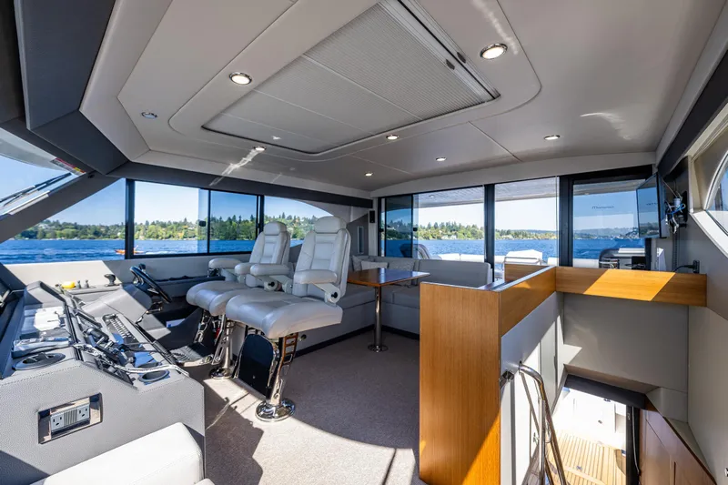 True North Yacht Photos Pics Luxurious interior of 2020 Maritimo 59 Motoryacht with panoramic windows and plush seating.