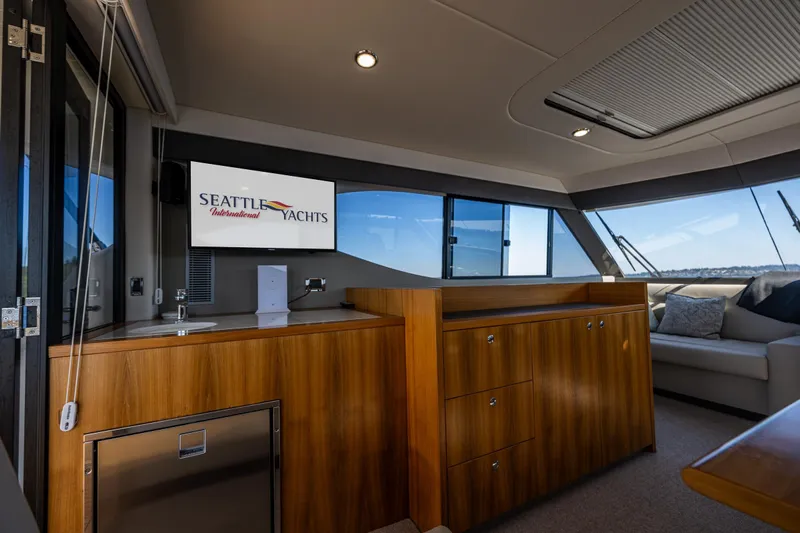 True North Yacht Photos Pics Interior of 2020 Maritimo 59 Motoryacht with wood cabinetry and Seattle Yachts display.