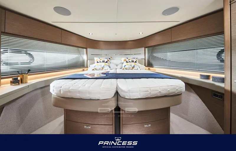  Yacht Photos Pics Luxurious interior of 2024 Princess V55 yacht with elegant bedding and modern design.