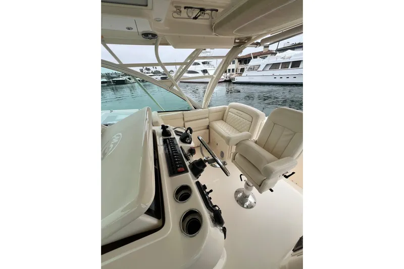 Be Chumming Yacht Photos Pics 2018 Grady-White Express 370 boat interior with helm and seating, docked at marina.