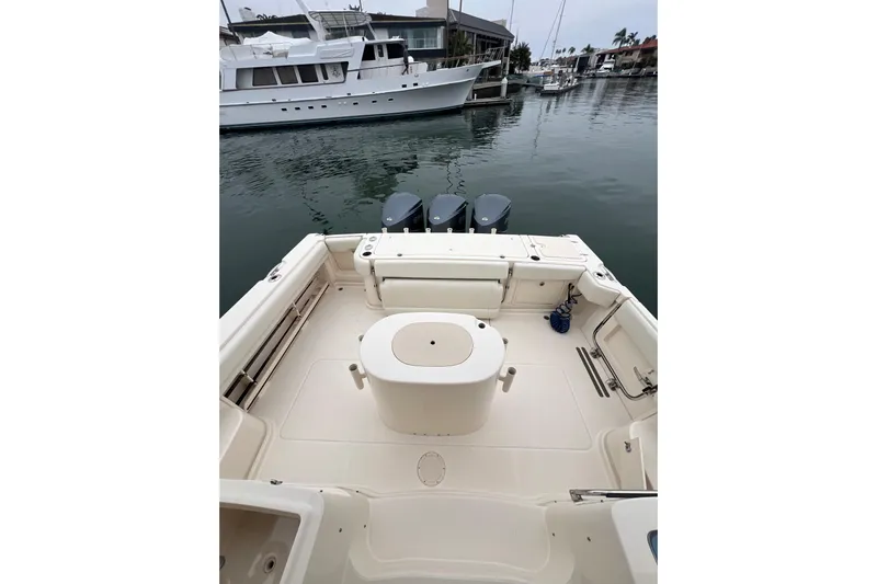 Be Chumming Yacht Photos Pics 2018 Grady-White Express 370 boat deck with triple outboard motors in marina.