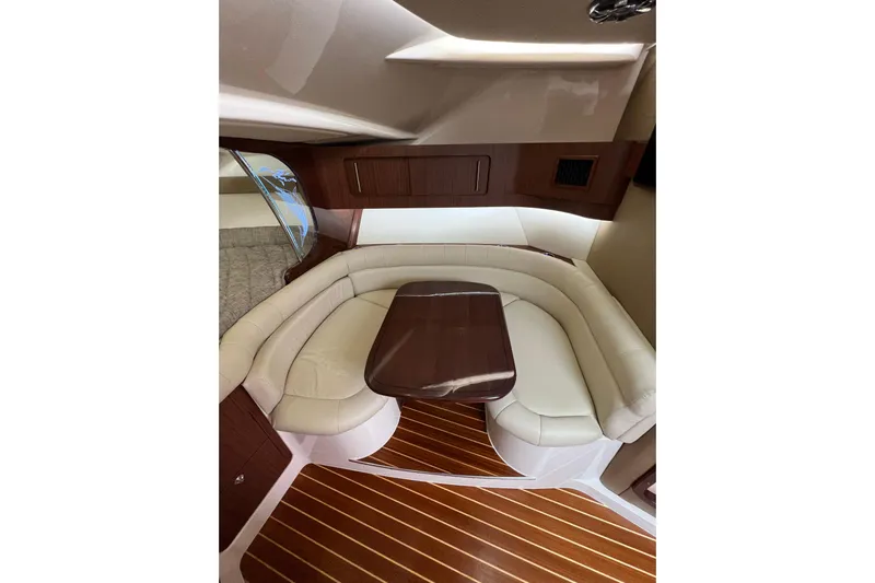Be Chumming Yacht Photos Pics 2018 Grady-White Express 370 cabin interior with elegant seating and wooden table.