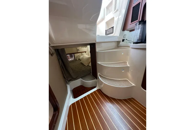 Be Chumming Yacht Photos Pics Interior of 2018 Grady-White Express 370 boat with wooden flooring and cozy cabin.