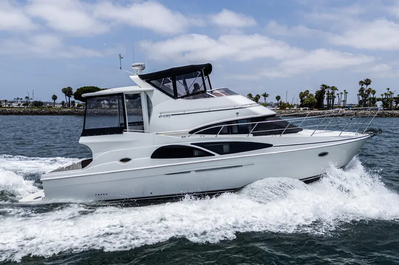  Yacht Photos Pics 2005 Carver 41 Cockpit Motor Yacht cruising on water, clear sky background.