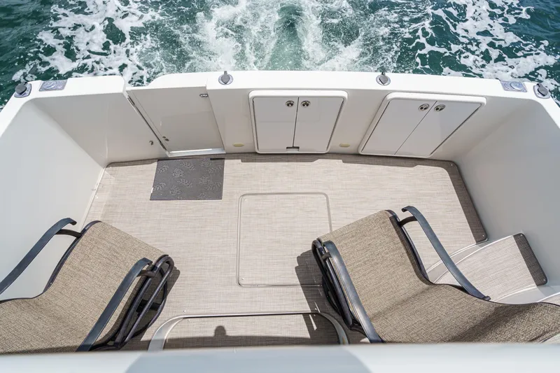  Yacht Photos Pics 2005 Carver 41 Cockpit Motor Yacht deck with chairs, overlooking ocean waves.