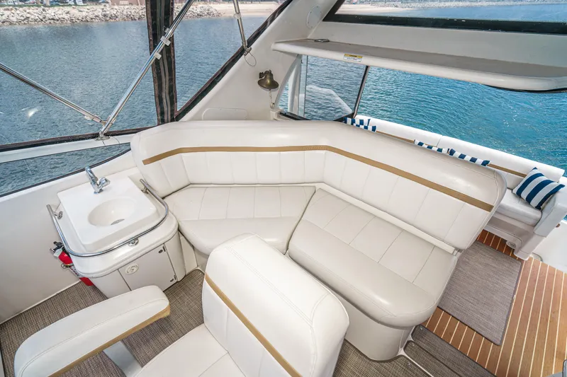  Yacht Photos Pics Luxurious 2005 Carver 41 Cockpit Motor Yacht interior with white seating and ocean view.