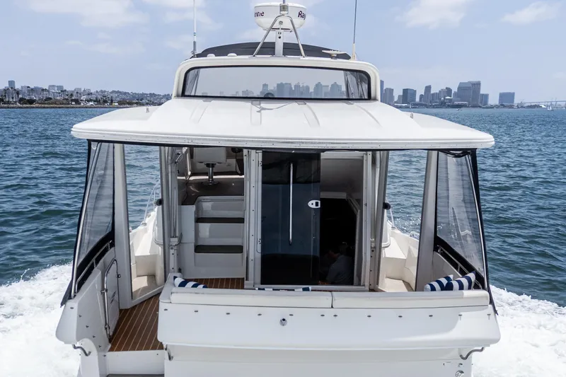  Yacht Photos Pics 2005 Carver 41 Cockpit Motor Yacht cruising with city skyline in background.