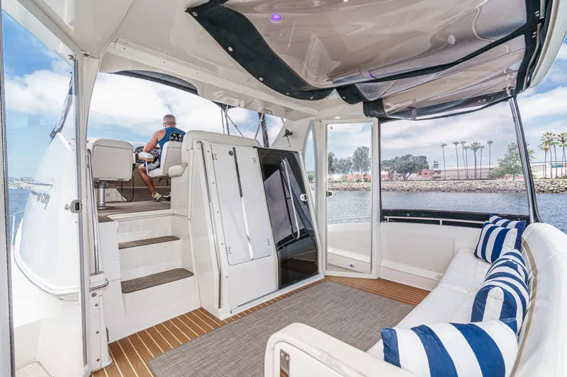  Yacht Photos Pics 2005 Carver 41 Cockpit Motor Yacht interior with seating, striped cushions, and water view.