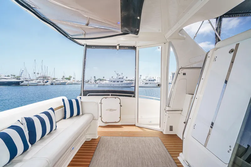  Yacht Photos Pics 2005 Carver 41 Cockpit Motor Yacht interior with striped cushions, overlooking marina.