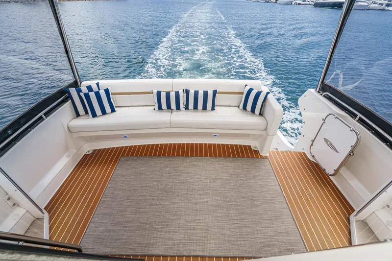  Yacht Photos Pics 2005 Carver 41 Cockpit Motor Yacht with striped cushions, cruising on open water.