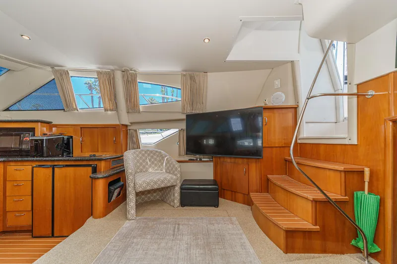  Yacht Photos Pics Interior of 2005 Carver 41 Cockpit Motor Yacht with modern furnishings and wooden accents.