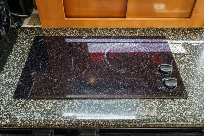  Yacht Photos Pics Electric stovetop on granite counter in 2005 Carver 41 Cockpit Motor Yacht kitchen.