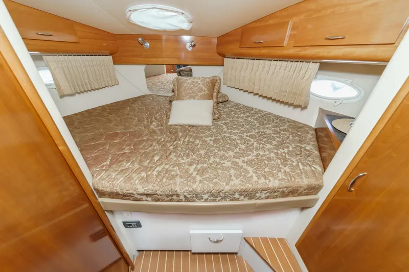  Yacht Photos Pics 2005 Carver 41 Cockpit Motor Yacht bedroom with wood accents and patterned bedding.