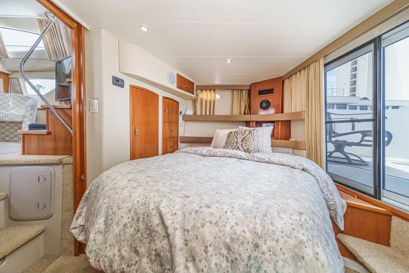  Yacht Photos Pics Luxurious interior of 2005 Carver 41 Cockpit Motor Yacht with cozy bedroom and elegant decor.