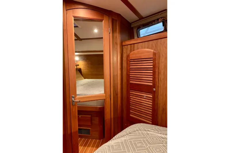 Lionheart Yacht Photos Pics 2006 Sabre 38 Hard Top Express cabin interior with wooden door and cozy bed.