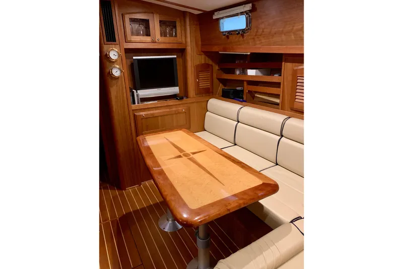 Lionheart Yacht Photos Pics Interior of 2006 Sabre 38 Hard Top Express yacht with wood finishes and seating area.