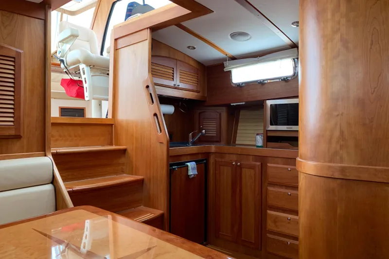 Lionheart Yacht Photos Pics Interior of 2006 Sabre 38 Hard Top Express yacht with wooden cabinetry and stairs.