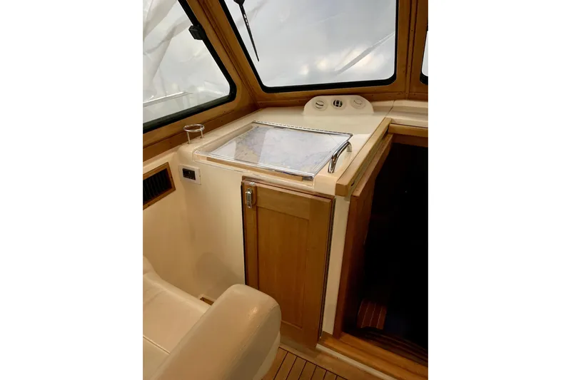 Lionheart Yacht Photos Pics 2006 Sabre 38 Hard Top Express interior with navigation station and wooden cabinetry.