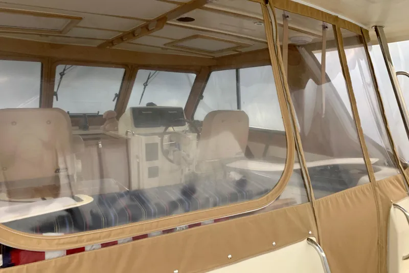 Lionheart Yacht Photos Pics 2006 Sabre 38 Hard Top Express interior with beige seating and helm.