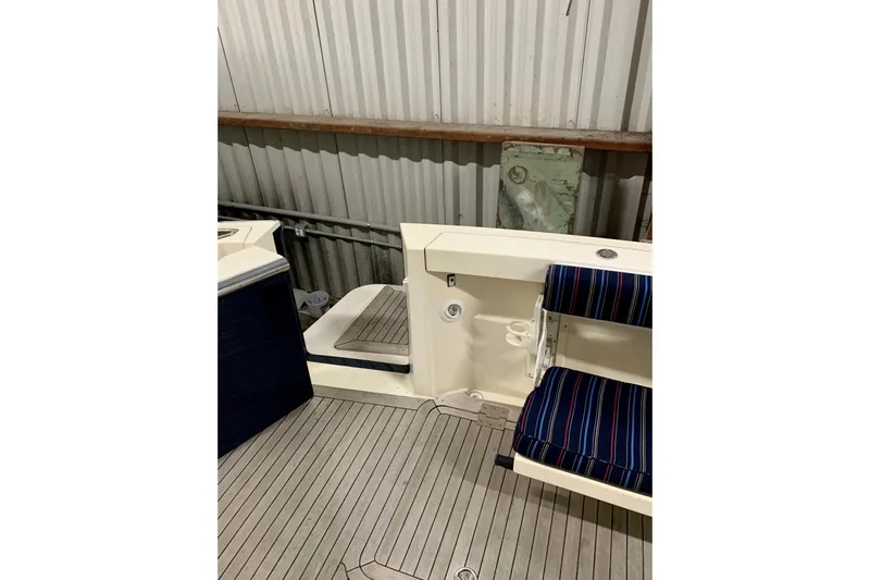 Lionheart Yacht Photos Pics 2006 Sabre 38 Hard Top Express boat interior with striped seating and wooden flooring.