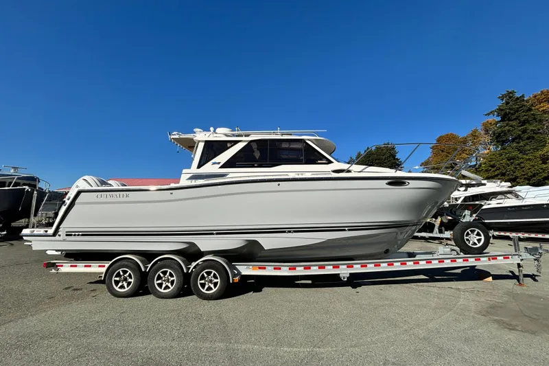  Yacht Photos Pics 2026 Cutwater C-288 Coupe boat on trailer under clear blue sky.