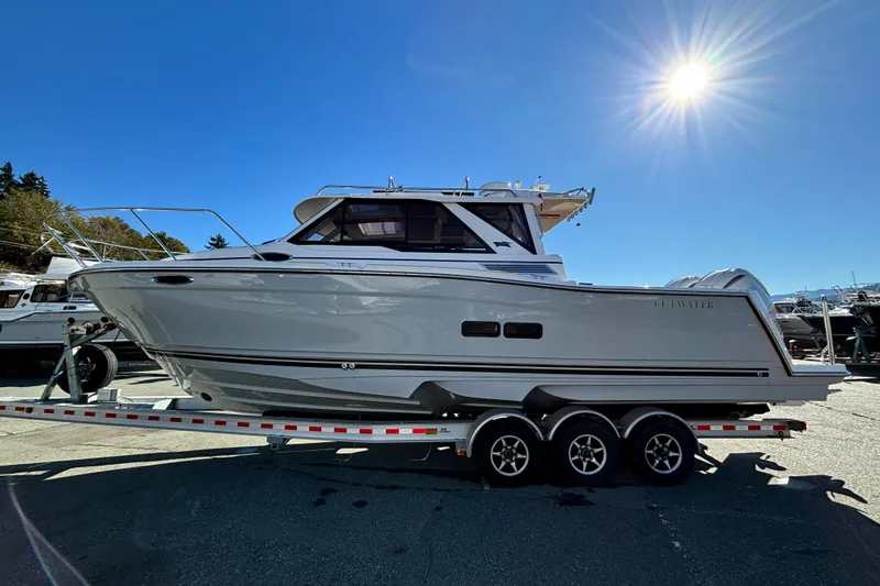  Yacht Photos Pics 2026 Cutwater C-288 Coupe boat on trailer under clear blue sky.