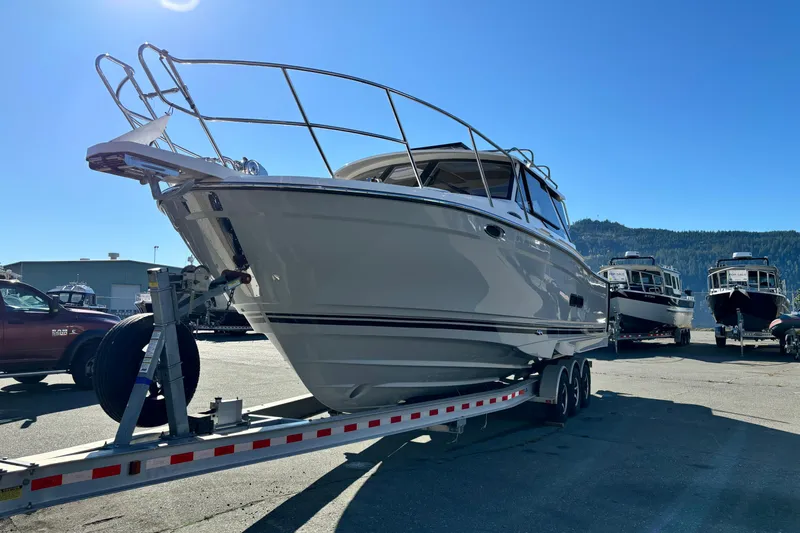  Yacht Photos Pics 2026 Cutwater C-288 Coupe boat on trailer under clear blue sky.