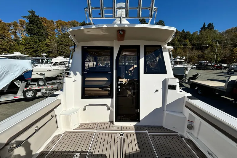  Yacht Photos Pics 2026 Cutwater C-288 Coupe boat, rear view, docked with open cockpit and clear skies.