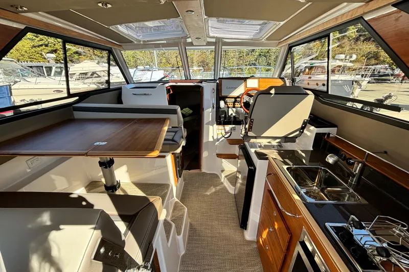  Yacht Photos Pics Interior of 2026 Cutwater C-288 Coupe boat with modern kitchen and seating area.