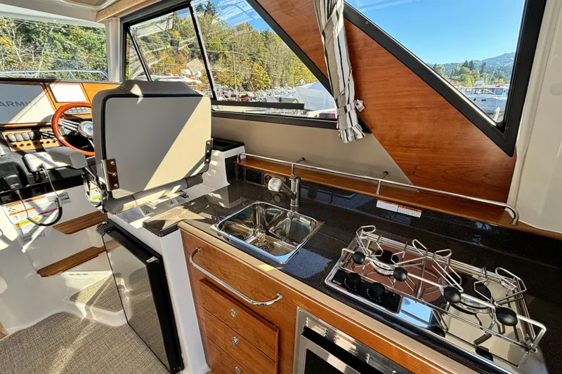  Yacht Photos Pics Interior of 2026 Cutwater C-288 Coupe featuring kitchen area with stove and sink.