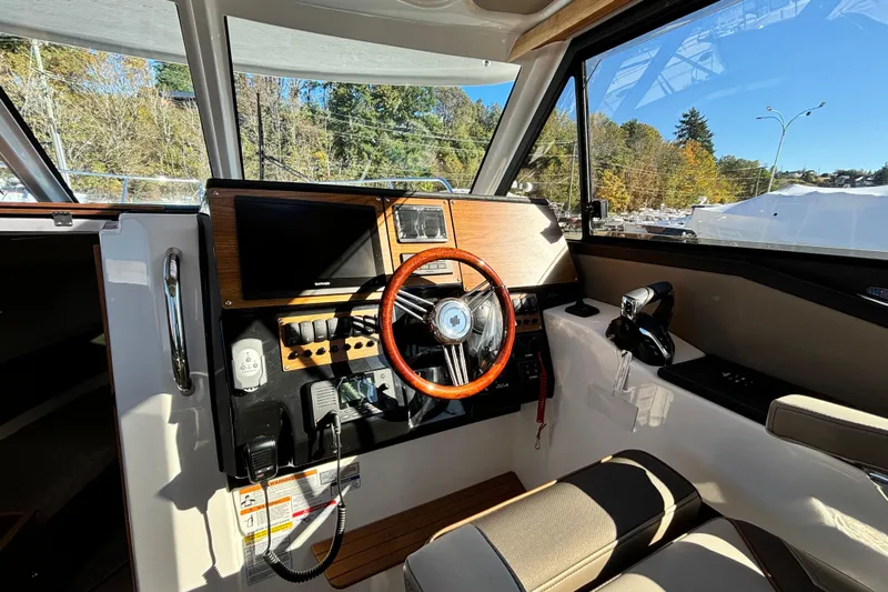  Yacht Photos Pics Interior cockpit of 2026 Cutwater C-288 Coupe, featuring modern controls and steering wheel.