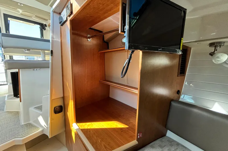  Yacht Photos Pics 2026 Cutwater C-288 Coupe interior with wooden storage and mounted TV.