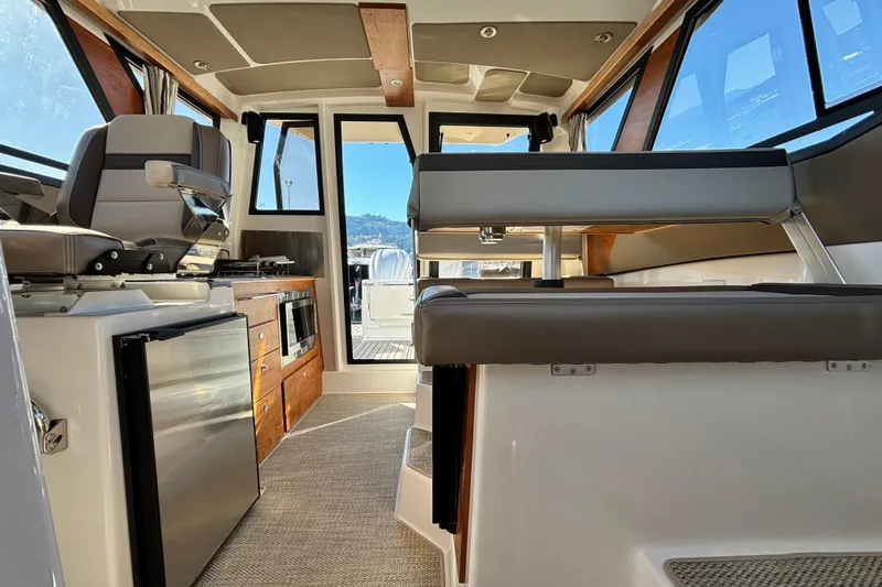  Yacht Photos Pics Interior of 2026 Cutwater C-288 Coupe, featuring modern seating and kitchen amenities.