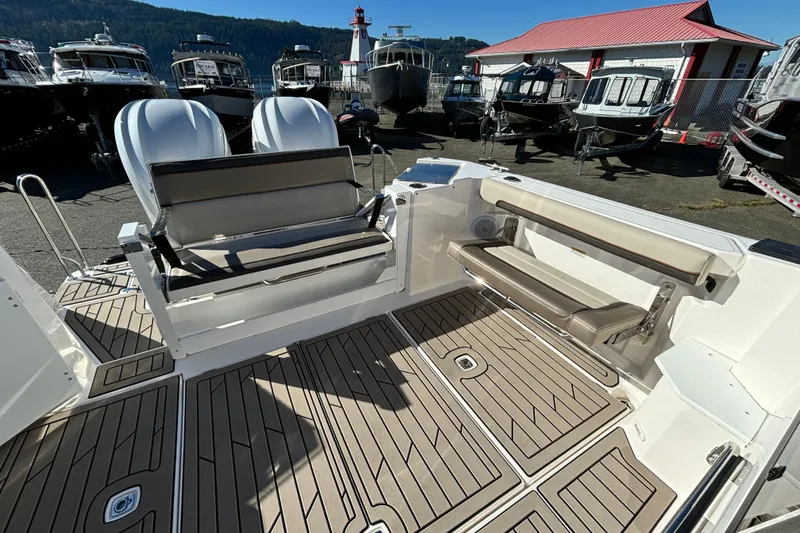  Yacht Photos Pics 2026 Cutwater C-288 Coupe boat interior with seating and deck, docked near other boats.