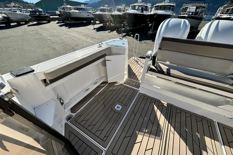  Yacht Photos Pics 2026 Cutwater C-288 Coupe boat interior with seating and deck, docked among other boats.