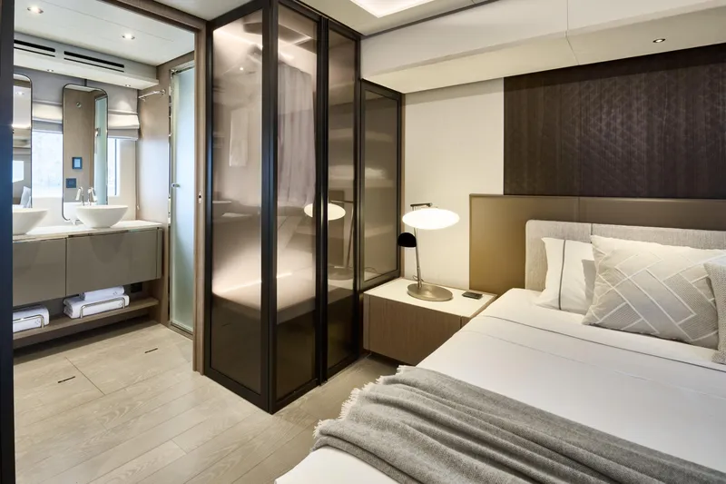  Yacht Photos Pics Luxurious Prestige M7 2026 yacht bedroom with modern ensuite bathroom and elegant decor.