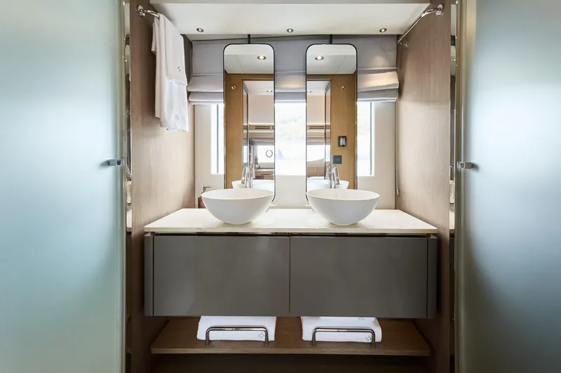  Yacht Photos Pics Luxurious bathroom interior of 2026 Prestige M7 yacht with dual sinks and modern design.