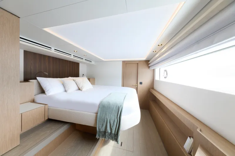  Yacht Photos Pics Luxurious bedroom interior of 2026 Prestige M7 yacht with modern design and natural lighting.