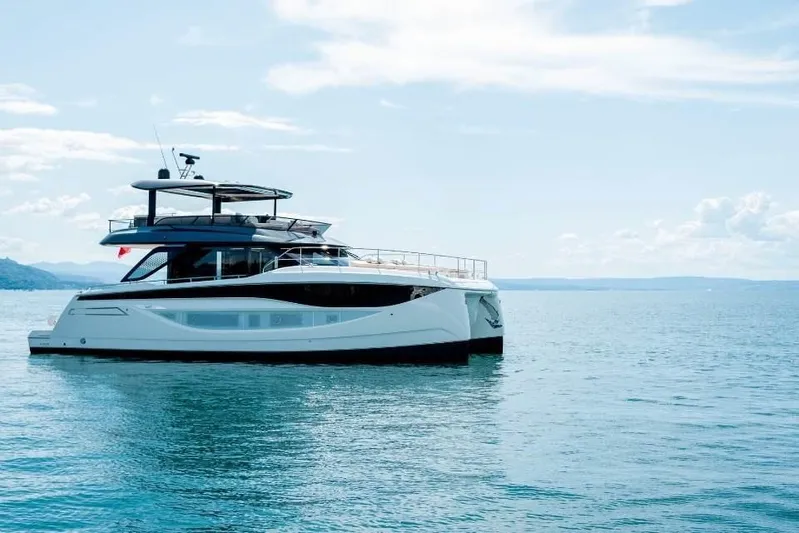  Yacht Photos Pics 2026 Prestige Yachts M7 on serene blue waters under a clear sky.