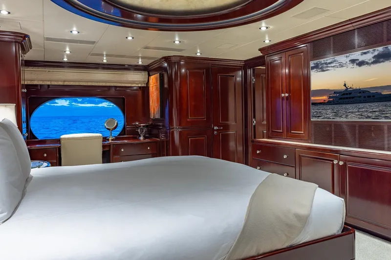 Lady Joy Yacht Photos Pics Luxurious 2007 Christensen Tri-Deck yacht bedroom with ocean view and elegant wood furnishings.
