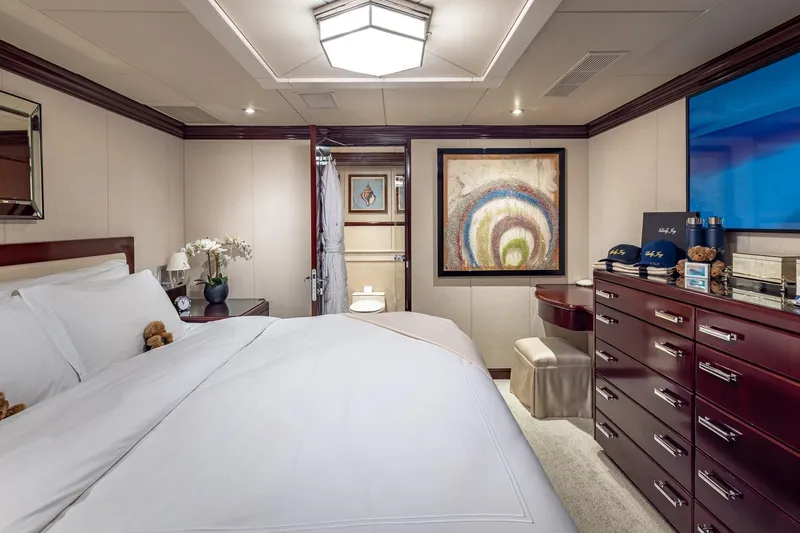 Lady Joy Yacht Photos Pics Luxurious bedroom on 2007 Christensen Tri-Deck yacht with elegant decor and modern amenities.