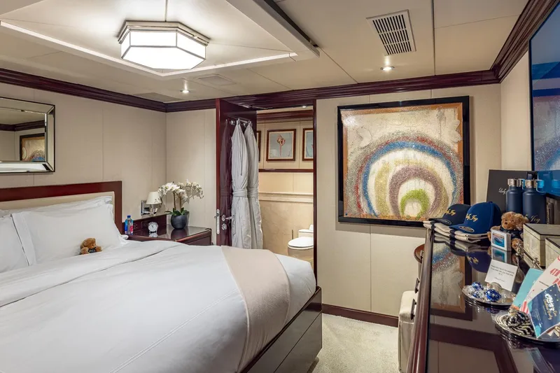 Lady Joy Yacht Photos Pics Luxurious bedroom on 2007 Christensen Tri-Deck yacht with elegant decor and modern amenities.