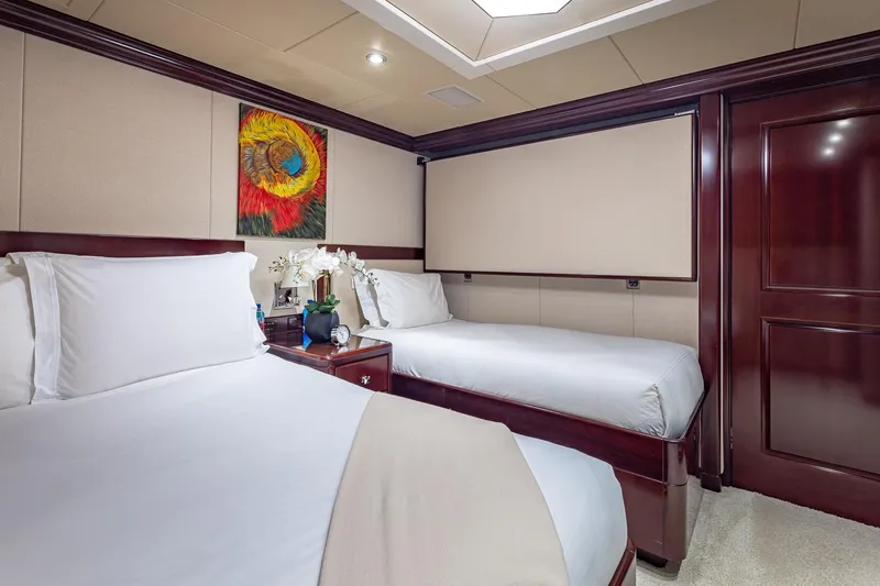 Lady Joy Yacht Photos Pics Luxurious twin bedroom on 2007 Christensen Tri-Deck yacht with elegant decor and artwork.