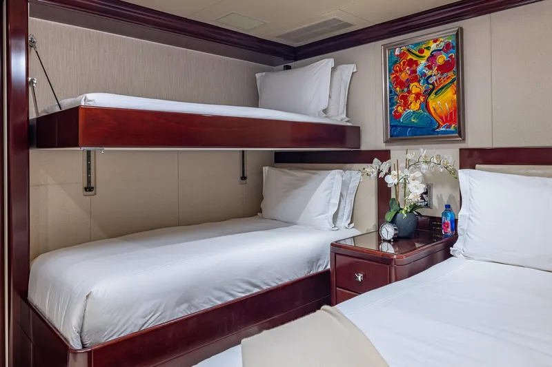 Lady Joy Yacht Photos Pics Luxurious 2007 Christensen Tri-Deck yacht cabin with bunk beds, vibrant artwork, and elegant decor.