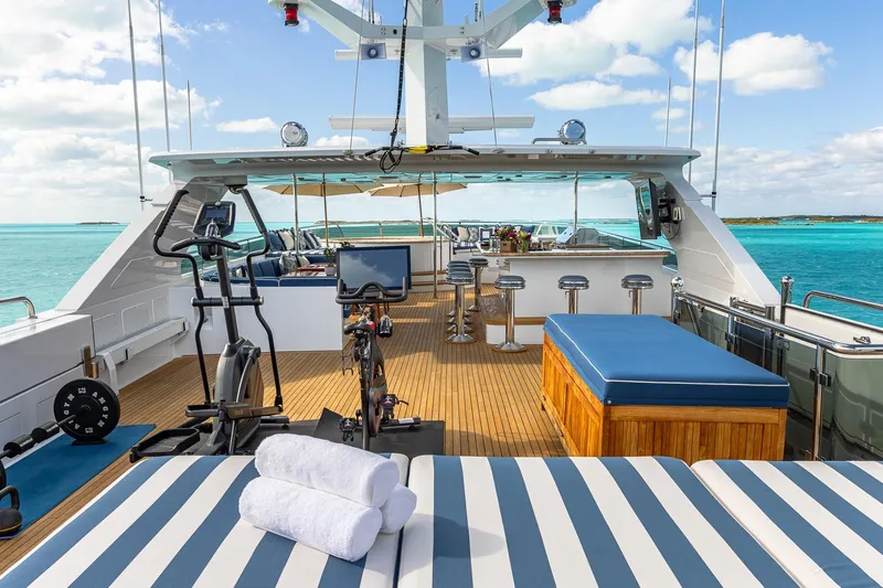 Lady Joy Yacht Photos Pics Luxurious 2007 Christensen Tri-Deck yacht deck with gym equipment and ocean view.