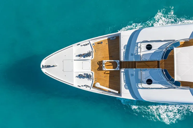 Lady Joy Yacht Photos Pics Aerial view of 2007 Christensen Tri-Deck yacht cruising in clear turquoise waters.