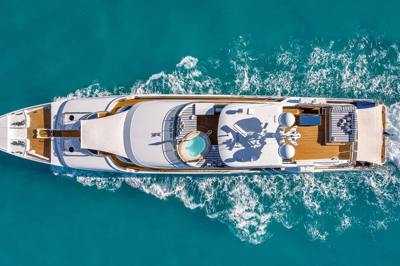 Lady Joy Yacht Photos Pics Aerial view of 2007 Christensen Tri-Deck yacht cruising in turquoise waters.