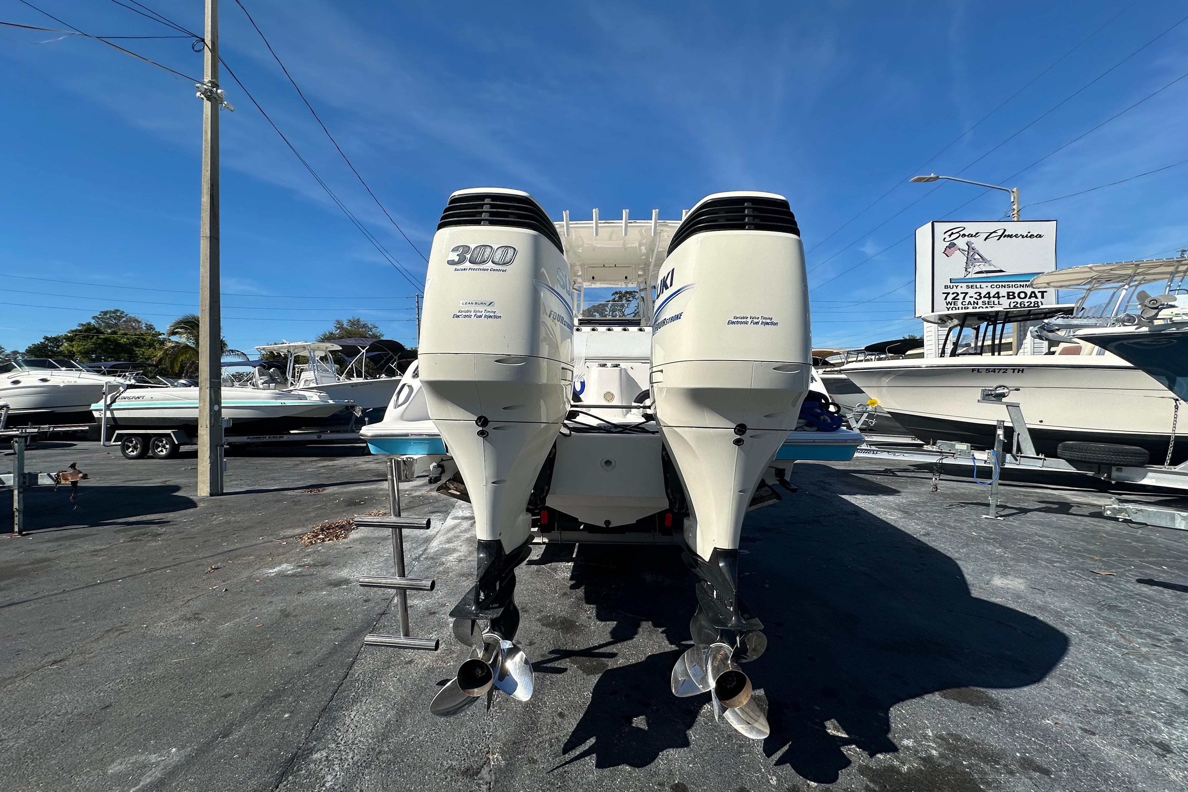 2004 Marlago 35 FS boat with twin Suzuki 300 outboard engines in a marina.
