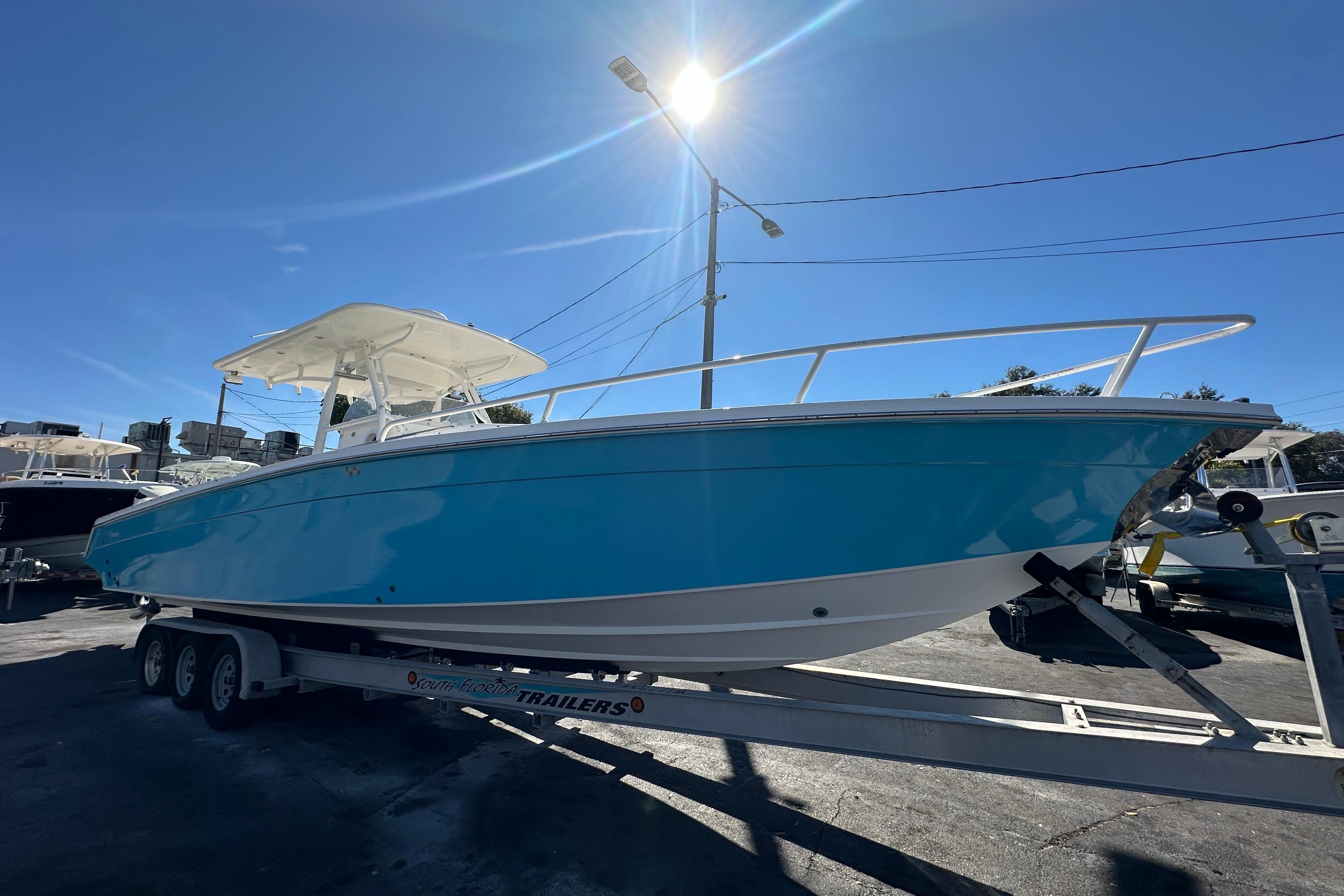 2004 Marlago 35 FS boat on trailer under bright sunlit sky.
