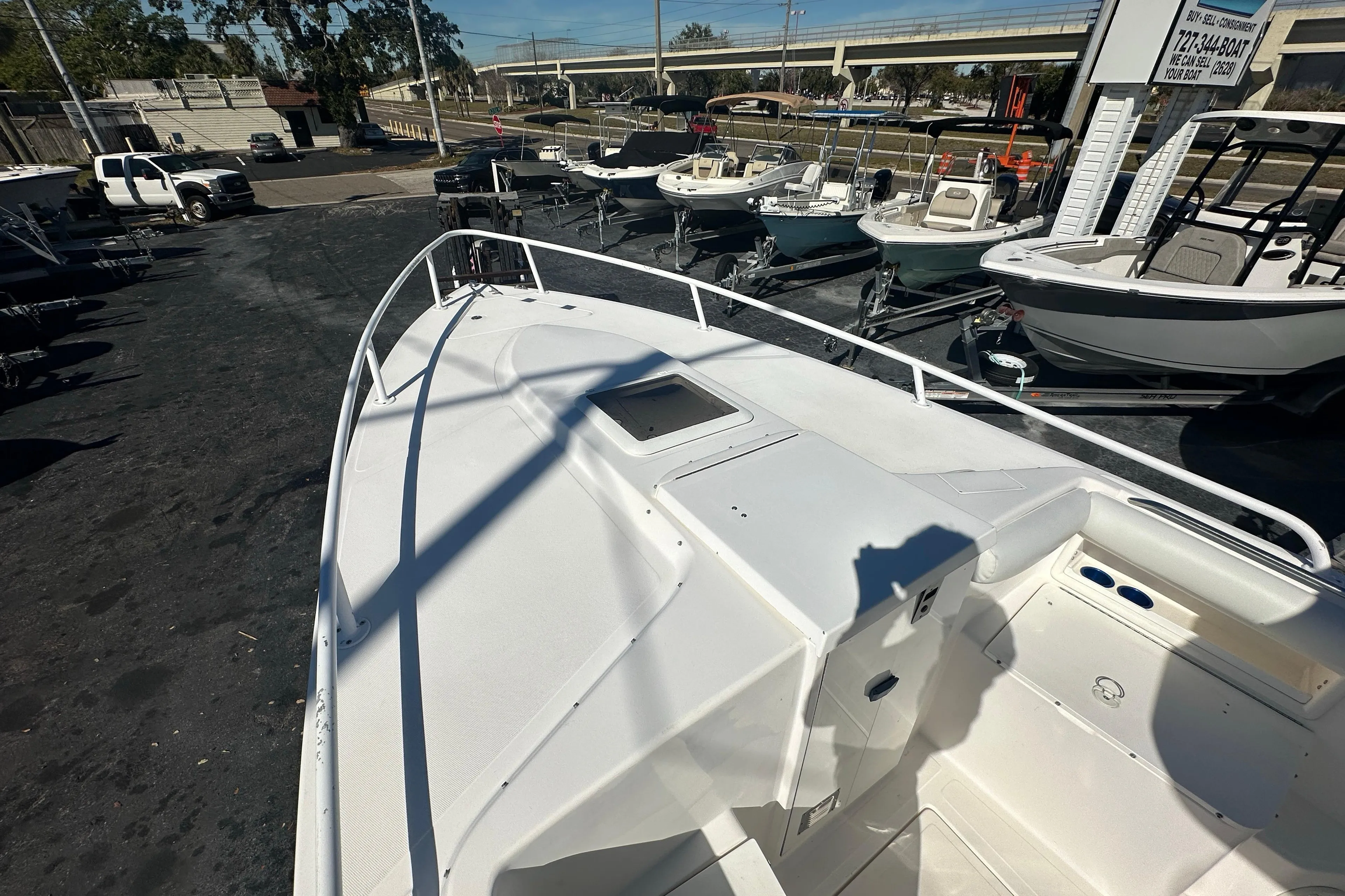 2004 Marlago 35 FS boat on display at a dealership with other boats.